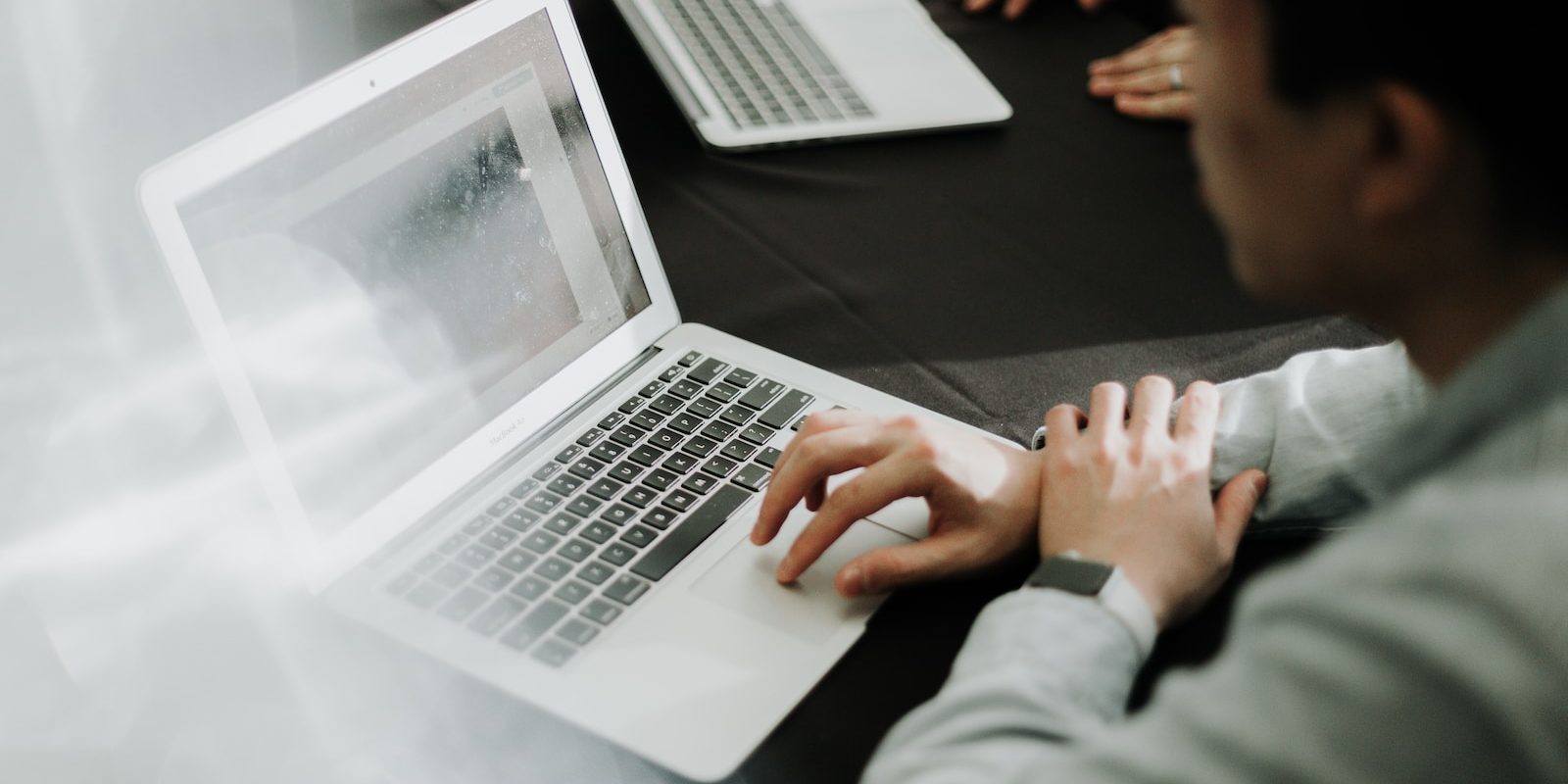 a man sitting in front of a laptop computer